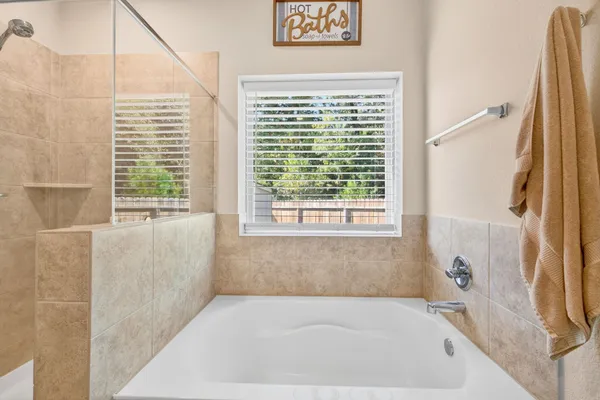 a bath tub sitting in a bathroom next to a window