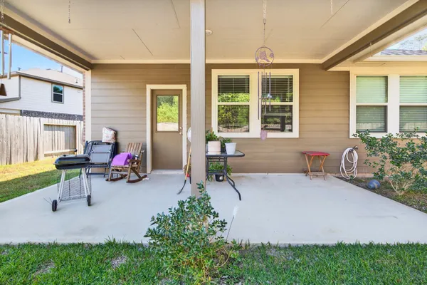 a view of a house with patio and a yard