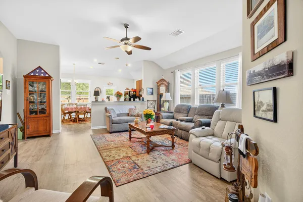 a living room with furniture and wooden floor