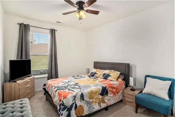 a bedroom with a large bed and a large window