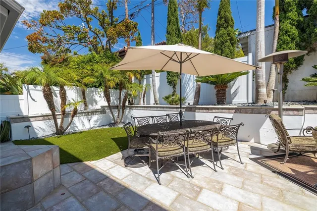 a view of backyard with outdoor seating and trees