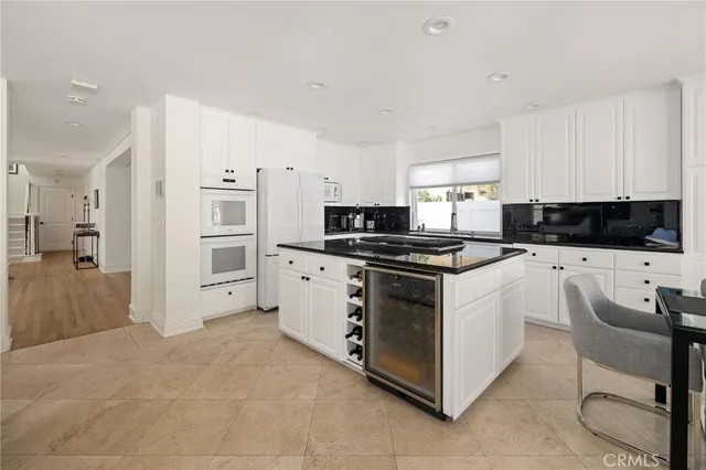 a kitchen with granite countertop a sink and a stove top oven