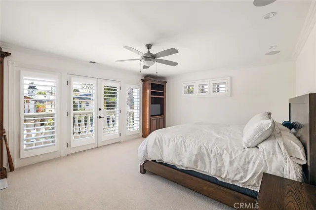 a bedroom with a large bed and a ceiling fan