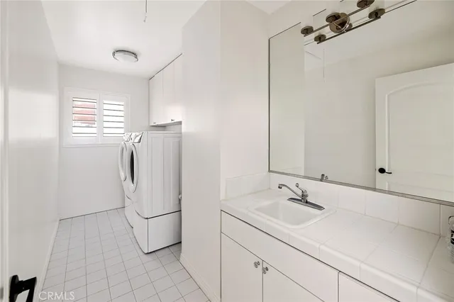 a bathroom with a sink a window and a shower
