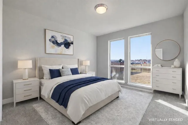 a bedroom with a bed and a large window