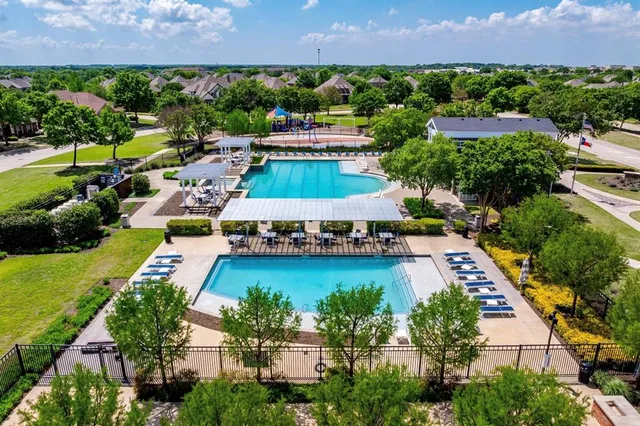an aerial view of a house with a garden and lake view