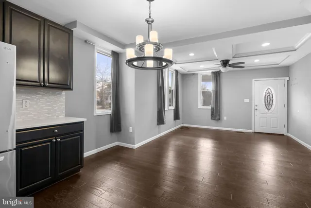 a kitchen with stainless steel appliances granite countertop a refrigerator a stove a sink and a microwave