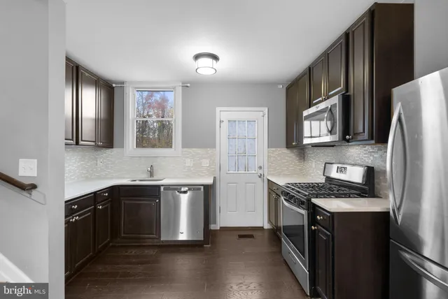 a view of a kitchen with a sink and a dishwasher