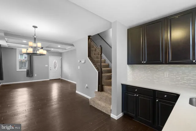 a kitchen with granite countertop stainless steel appliances and wooden cabinets