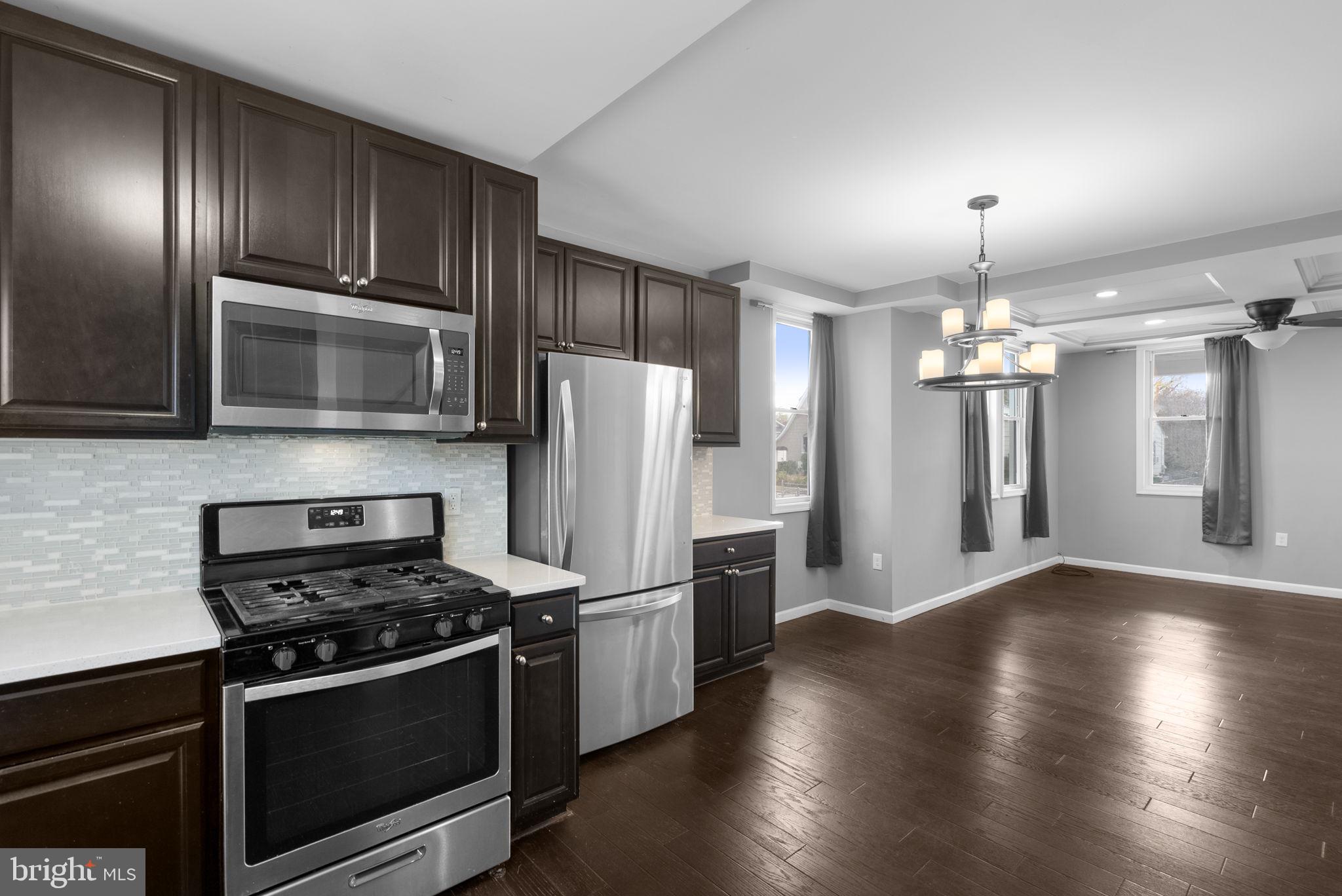 4308 Mainfield Avenue Baltimore, MD 21214 - Photo 18 of 41 a kitchen with granite countertop stainless steel appliances and wooden cabinets