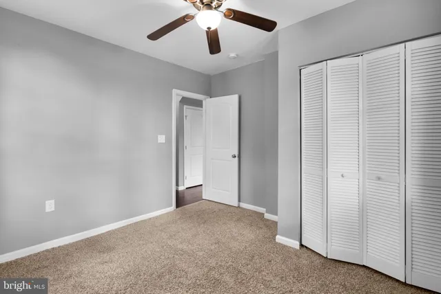 an empty room with windows and closet