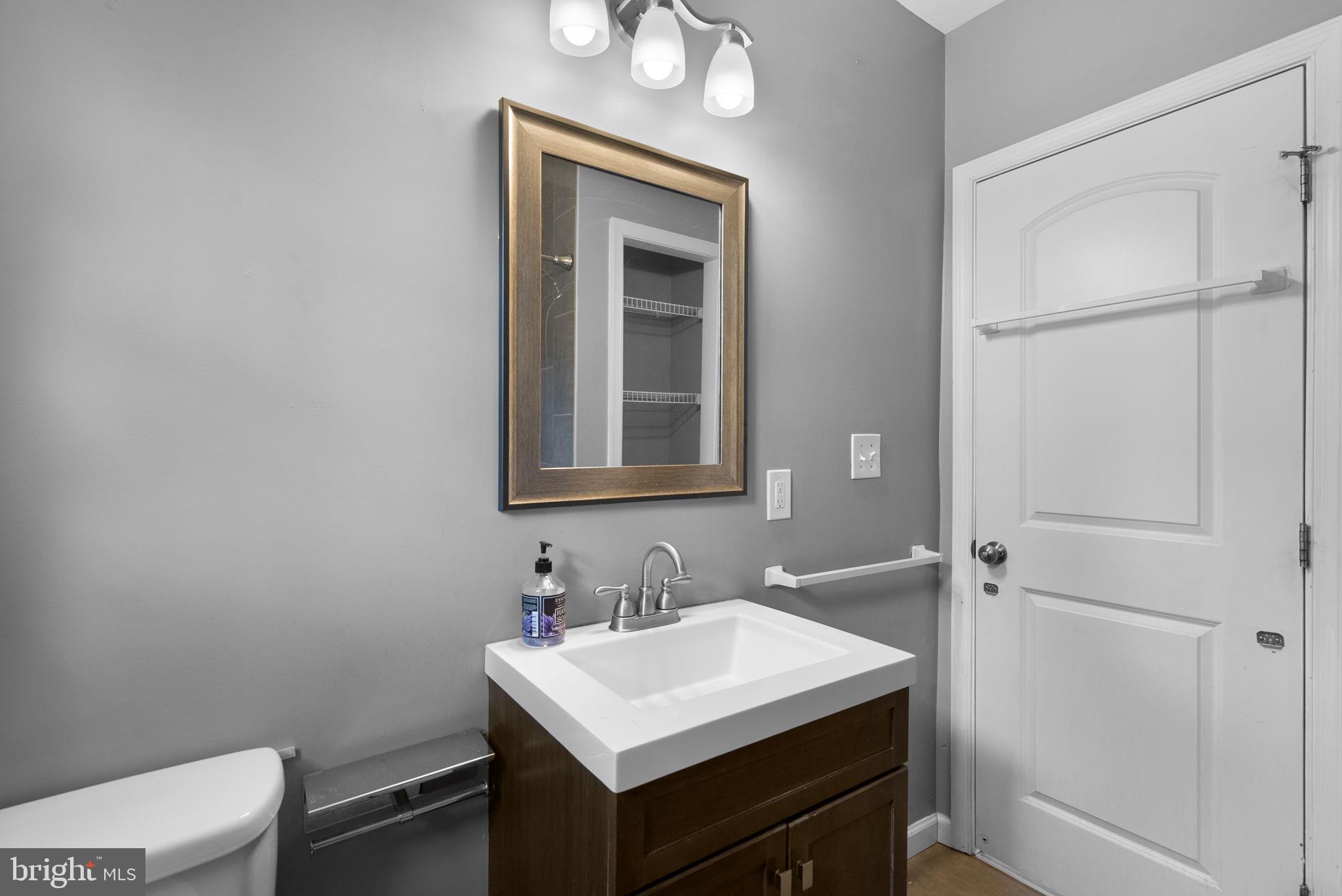 4308 Mainfield Avenue Baltimore, MD 21214 - Photo 26 of 41 a bathroom with a sink vanity and a toilet
