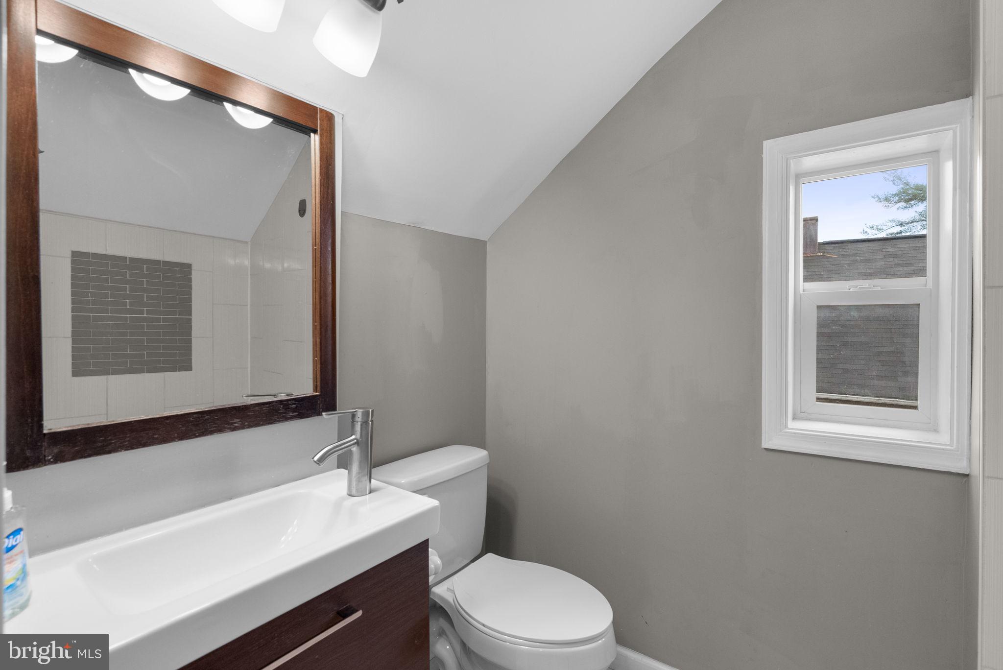 4308 Mainfield Avenue Baltimore, MD 21214 - Photo 31 of 41 a bathroom with a sink a toilet and mirror