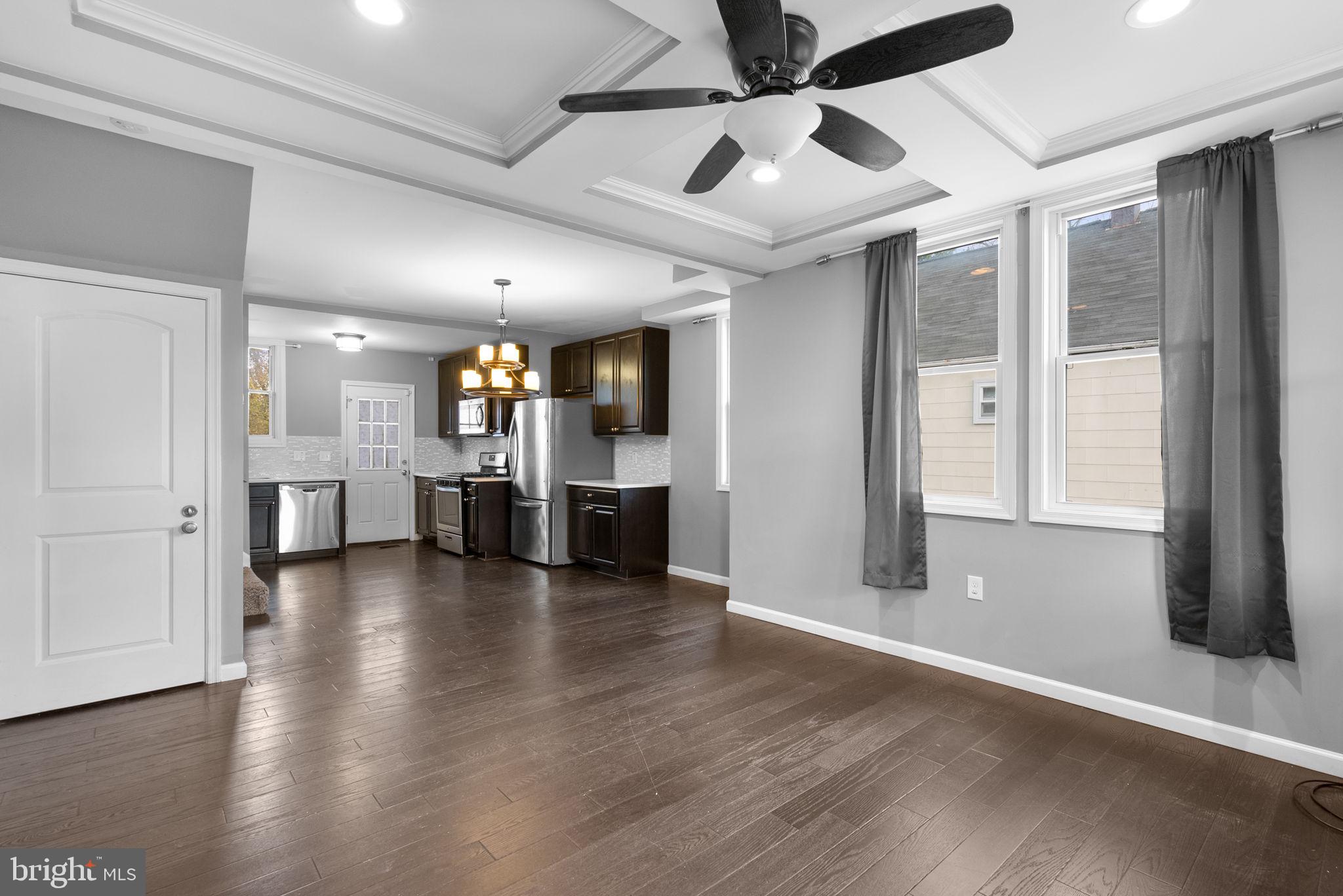 4308 Mainfield Avenue Baltimore, MD 21214 - Photo 5 of 41 an empty room with wooden floor and windows