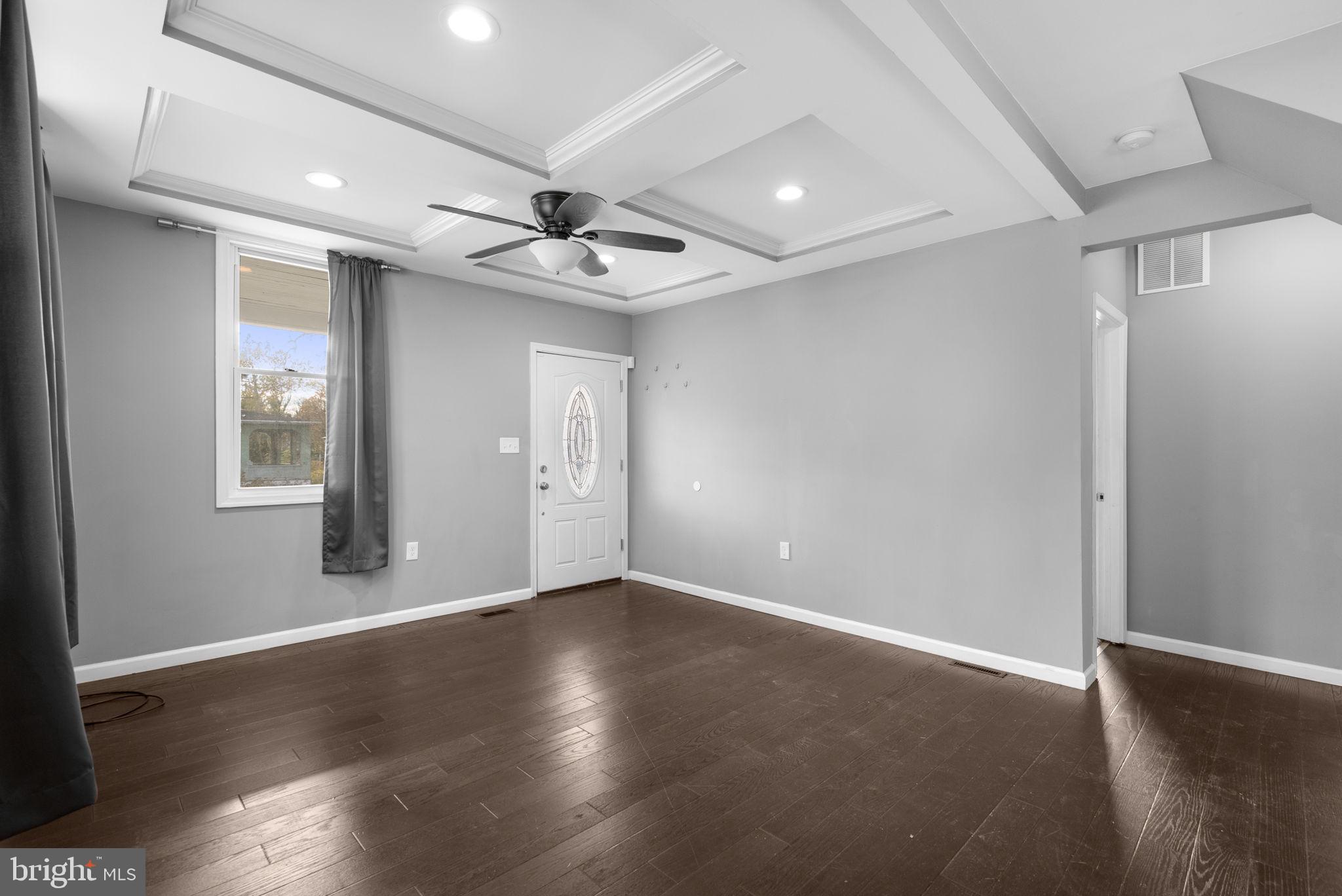 4308 Mainfield Avenue Baltimore, MD 21214 - Photo 7 of 41 a view of an empty room with a window and wooden floor
