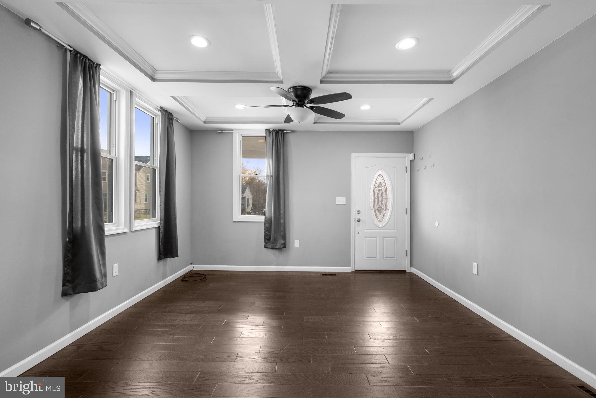 4308 Mainfield Avenue Baltimore, MD 21214 - Photo 8 of 41 an empty room with wooden floor and windows