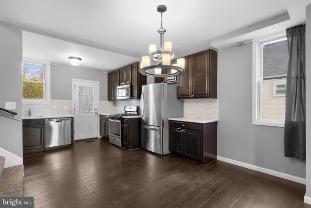 a view of a kitchen with a refrigerator and microwave