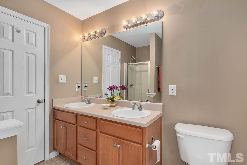 201 Tast Drive Wendell, NC 27591 - Photo 12 of 22 a bathroom with a toilet sink and mirror
