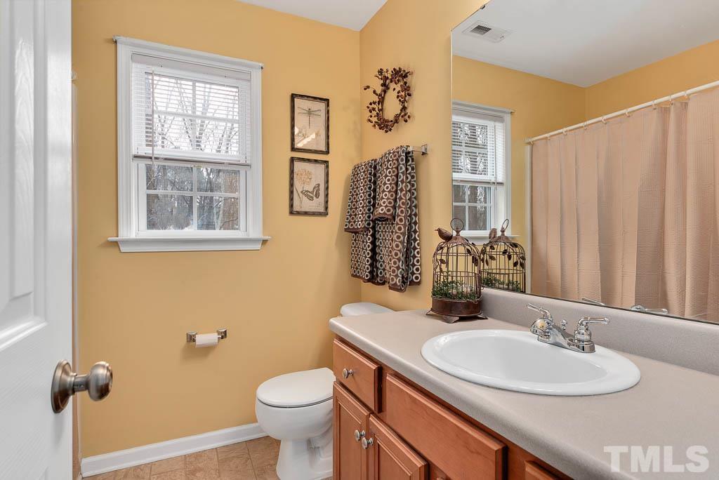 201 Tast Drive Wendell, NC 27591 - Photo 14 of 22 a bathroom with a granite countertop sink toilet and mirror