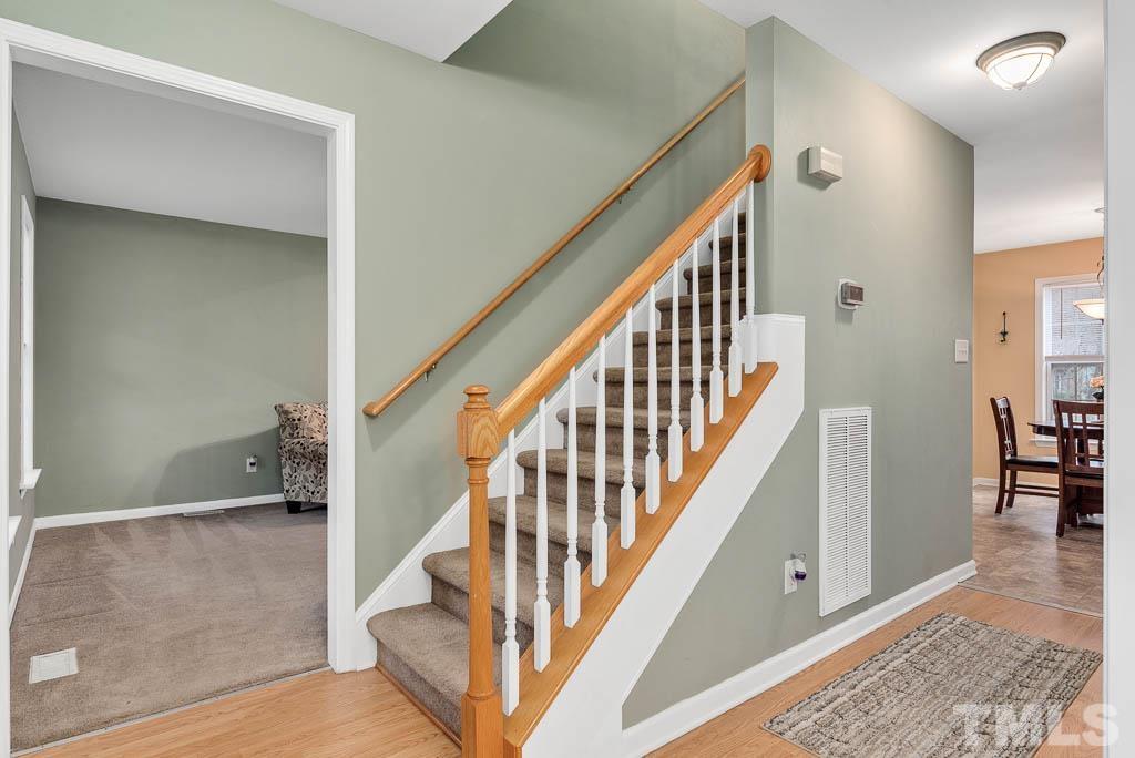 201 Tast Drive Wendell, NC 27591 - Photo 5 of 22 a view of staircase with lots of frames and a rug