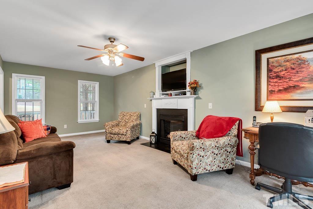 201 Tast Drive Wendell, NC 27591 - Photo 6 of 22 a living room with furniture a flat screen tv and a fireplace