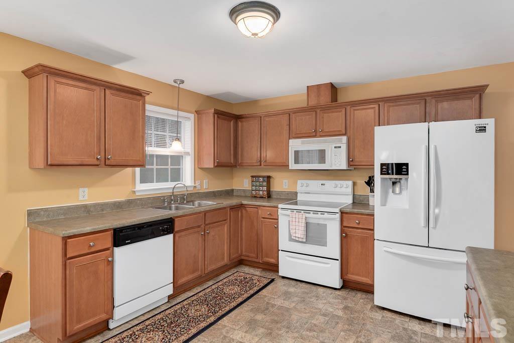 201 Tast Drive Wendell, NC 27591 - Photo 9 of 22 a kitchen with appliances a sink and cabinets