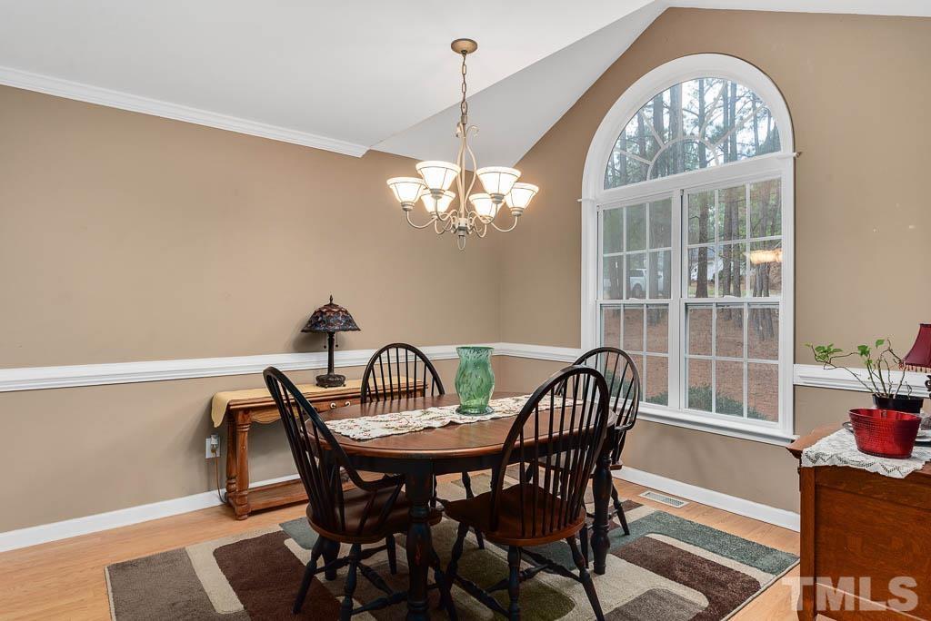 201 Tast Drive Wendell, NC 27591 - Photo 10 of 22 a view of a dining room with furniture a chandelier and wooden floor