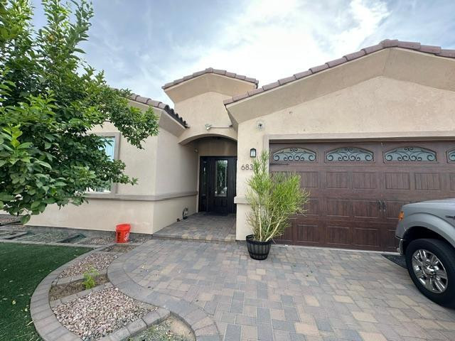 6830 North 14th Street Phoenix, AZ 85014 - Photo 28 of 28 a view of a white house with a small yard and a large tree