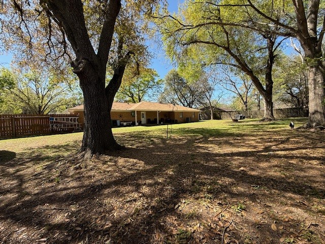 451 Pennington Street Lovelady, TX 75851 - Photo 21 of 28 a view of a yard with a tree