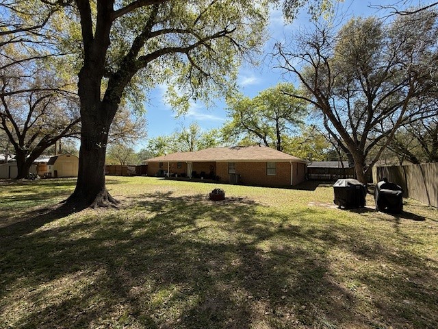 451 Pennington Street Lovelady, TX 75851 - Photo 22 of 28 a large tree in a yard next to a building