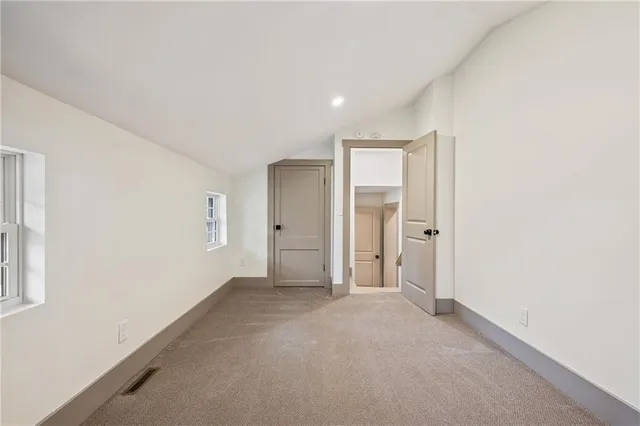 an empty room with windows and closet