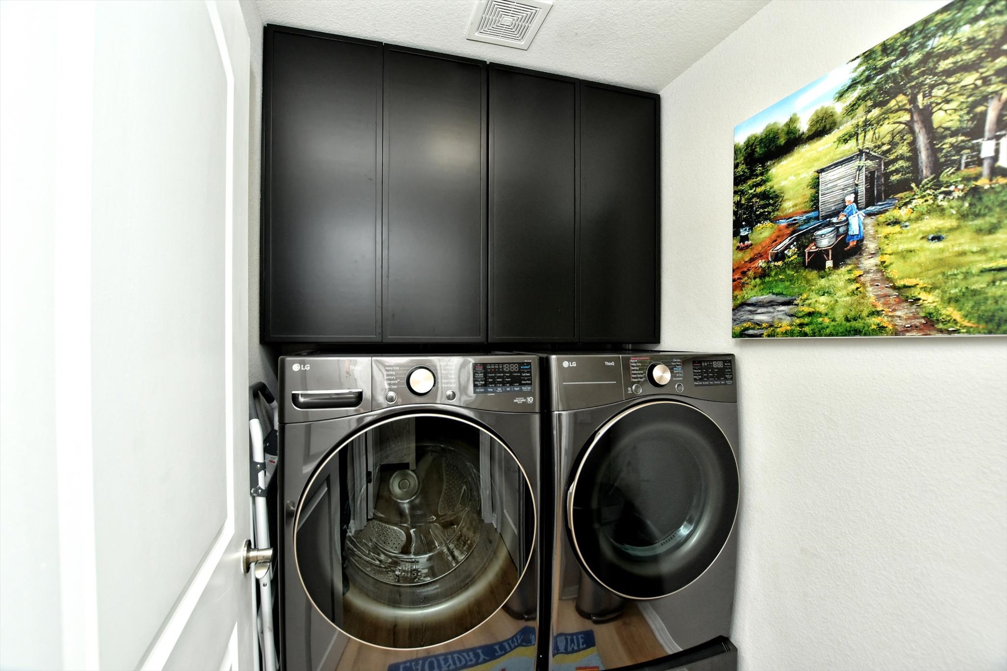 231 Hobby Street Georgetown, TX 78633 - Photo 13 of 29 A well-appointed laundry area features modern washer and dryer units with convenient overhead storage.