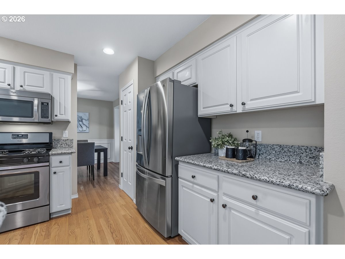 8361 Southwest 168th Avenue Beaverton, OR 97007 - Photo 11 of 31 a kitchen with stainless steel appliances granite countertop a refrigerator sink and cabinets