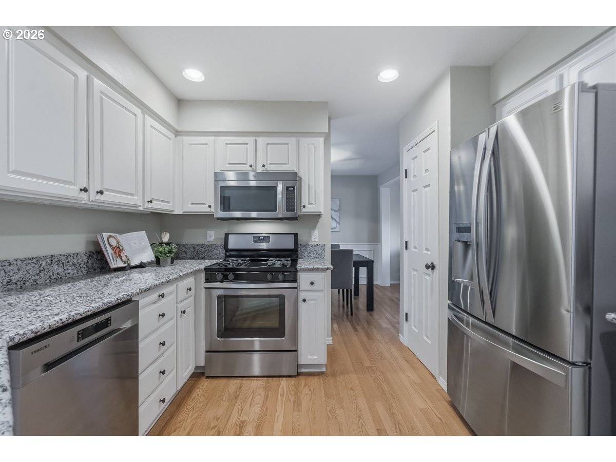 8361 Southwest 168th Avenue Beaverton, OR 97007 - Photo 13 of 31 a kitchen with stainless steel appliances granite countertop a refrigerator a stove a sink and a granite counter tops