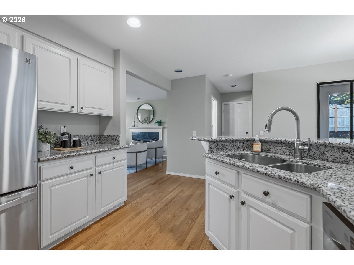 8361 Southwest 168th Avenue Beaverton, OR 97007 - Photo 14 of 31 a kitchen with a sink cabinets and wooden floor