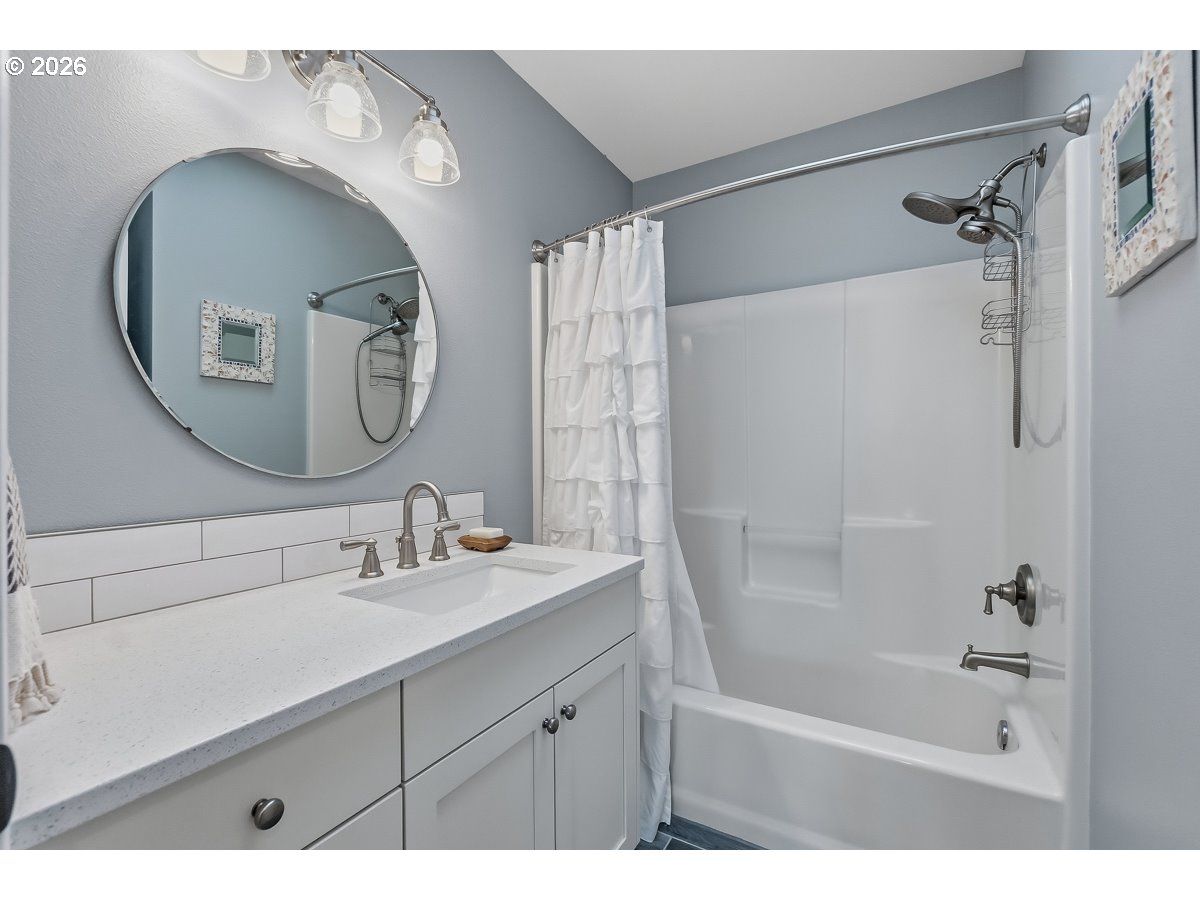 8361 Southwest 168th Avenue Beaverton, OR 97007 - Photo 18 of 31 a bathroom with a sink mirror and a shower