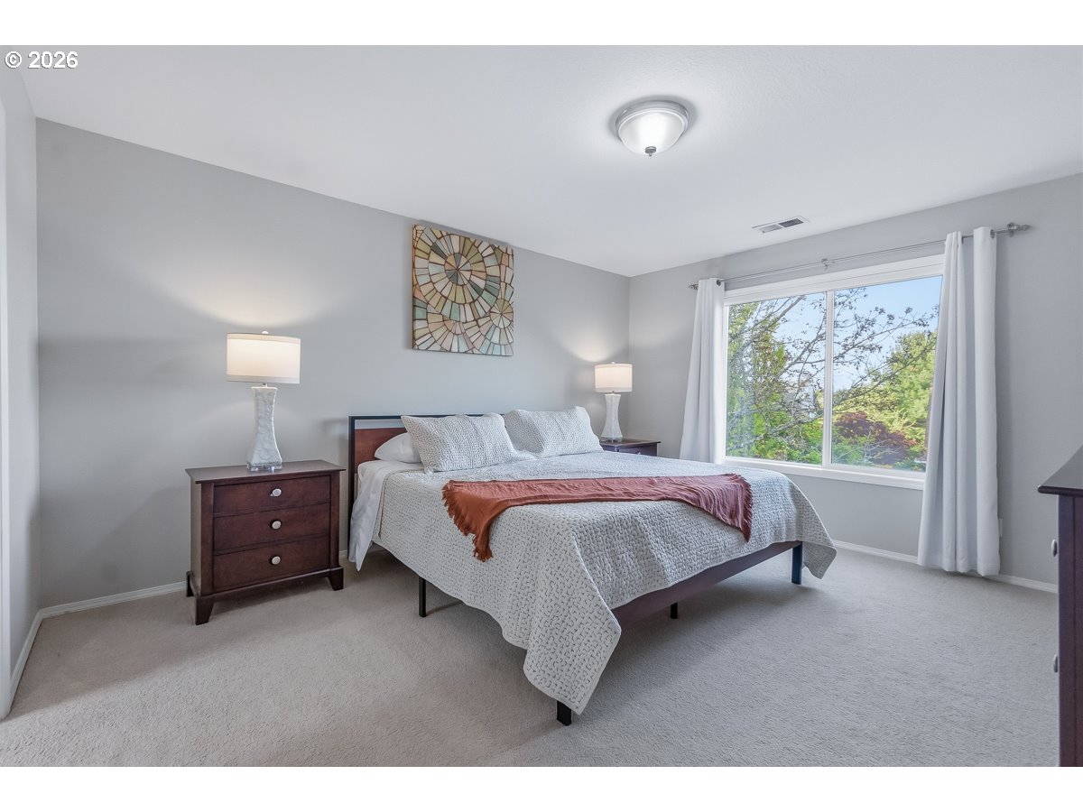 8361 Southwest 168th Avenue Beaverton, OR 97007 - Photo 20 of 31 a spacious bedroom with a bed and a window