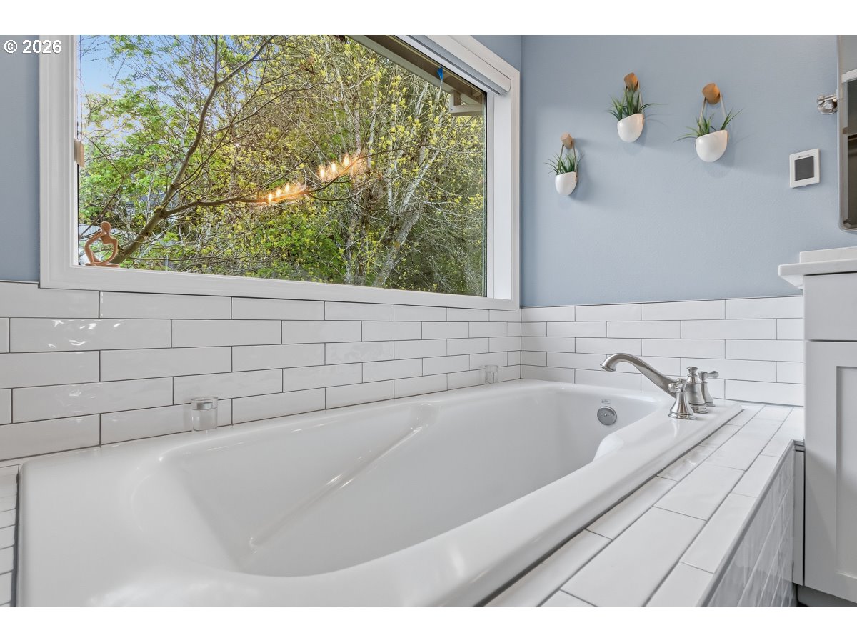 8361 Southwest 168th Avenue Beaverton, OR 97007 - Photo 25 of 31 a bath tub sitting in a bathroom next to a window