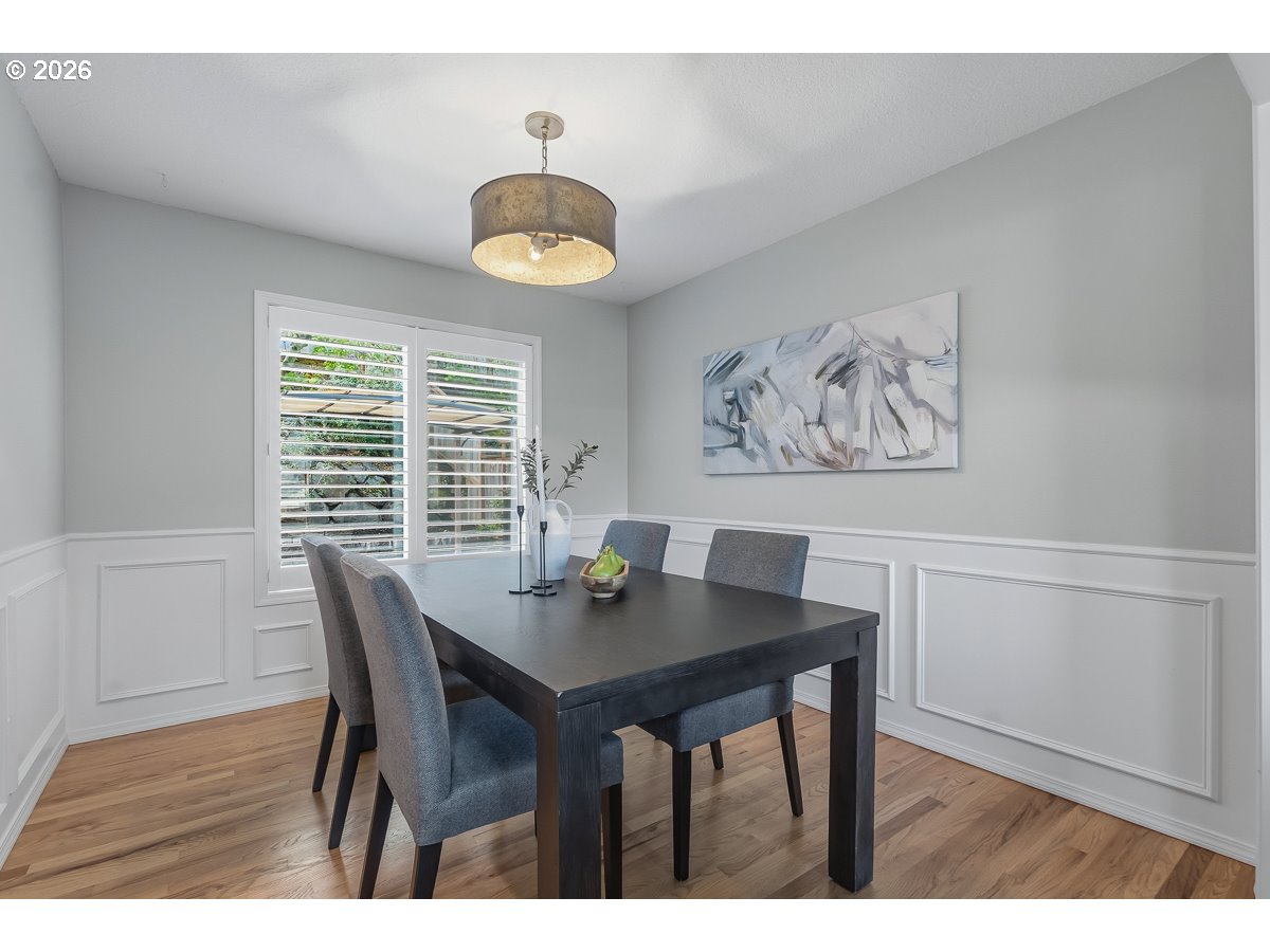 8361 Southwest 168th Avenue Beaverton, OR 97007 - Photo 8 of 31 a view of a dining room with furniture and wooden floor