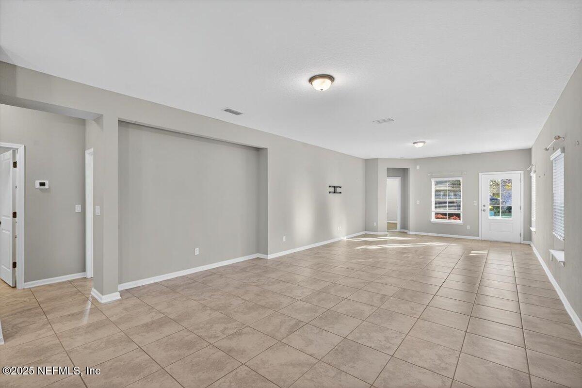 312 Clarys Run St. Augustine, FL 32092 - Photo 13 of 99 a view of an empty room with window and stairs