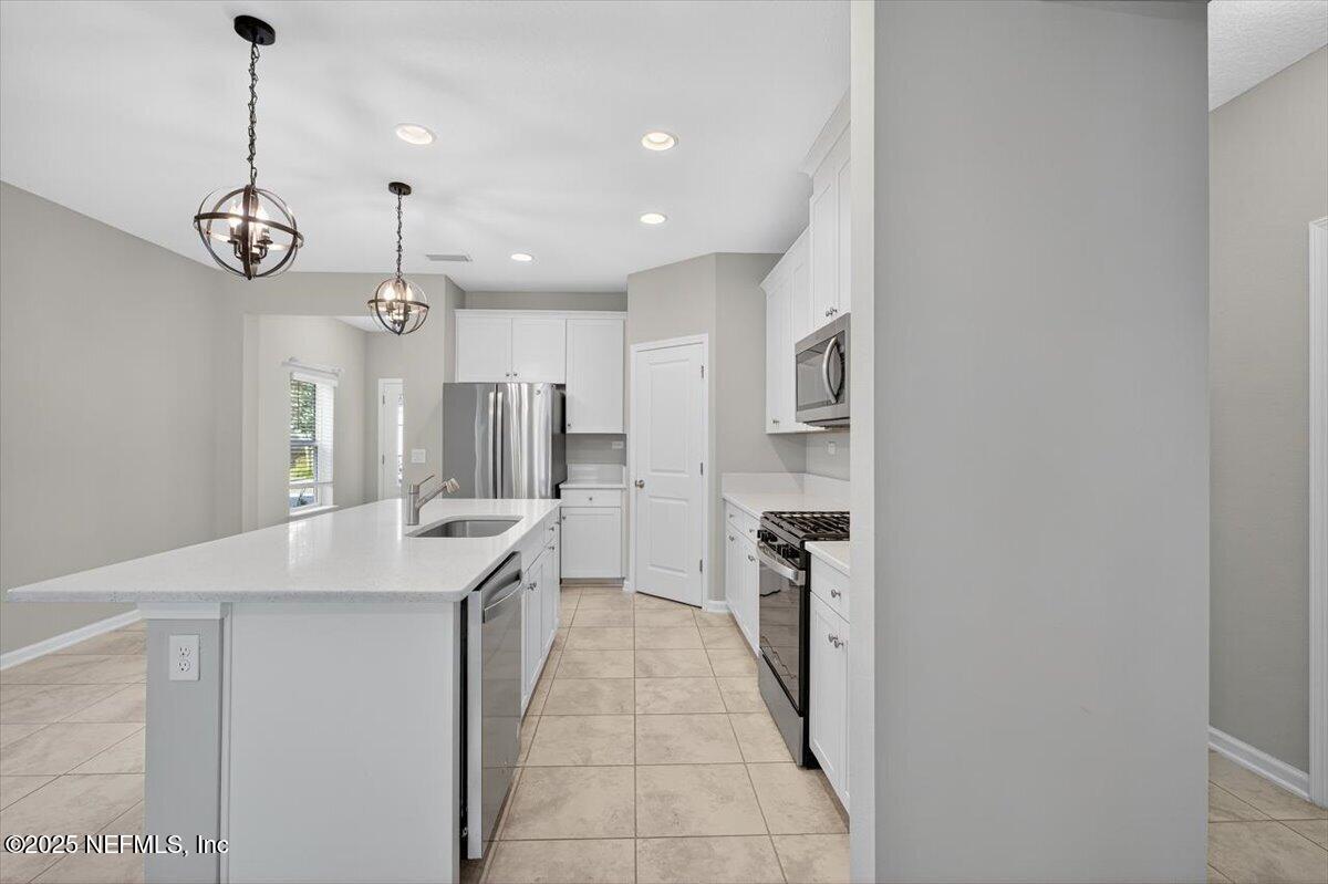 312 Clarys Run St. Augustine, FL 32092 - Photo 18 of 99 a kitchen with stainless steel appliances granite countertop a sink and a refrigerator