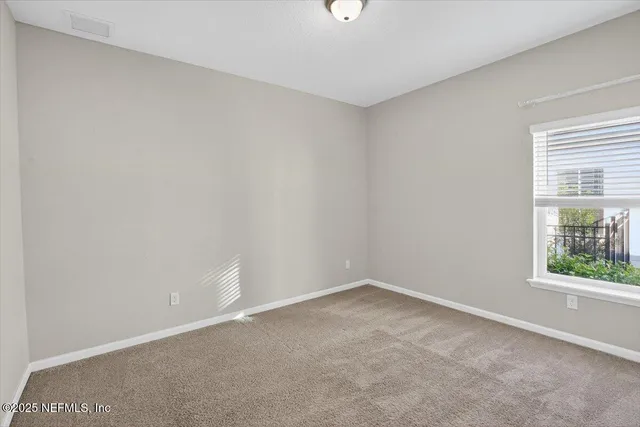 a view of a house with a yard and large tree