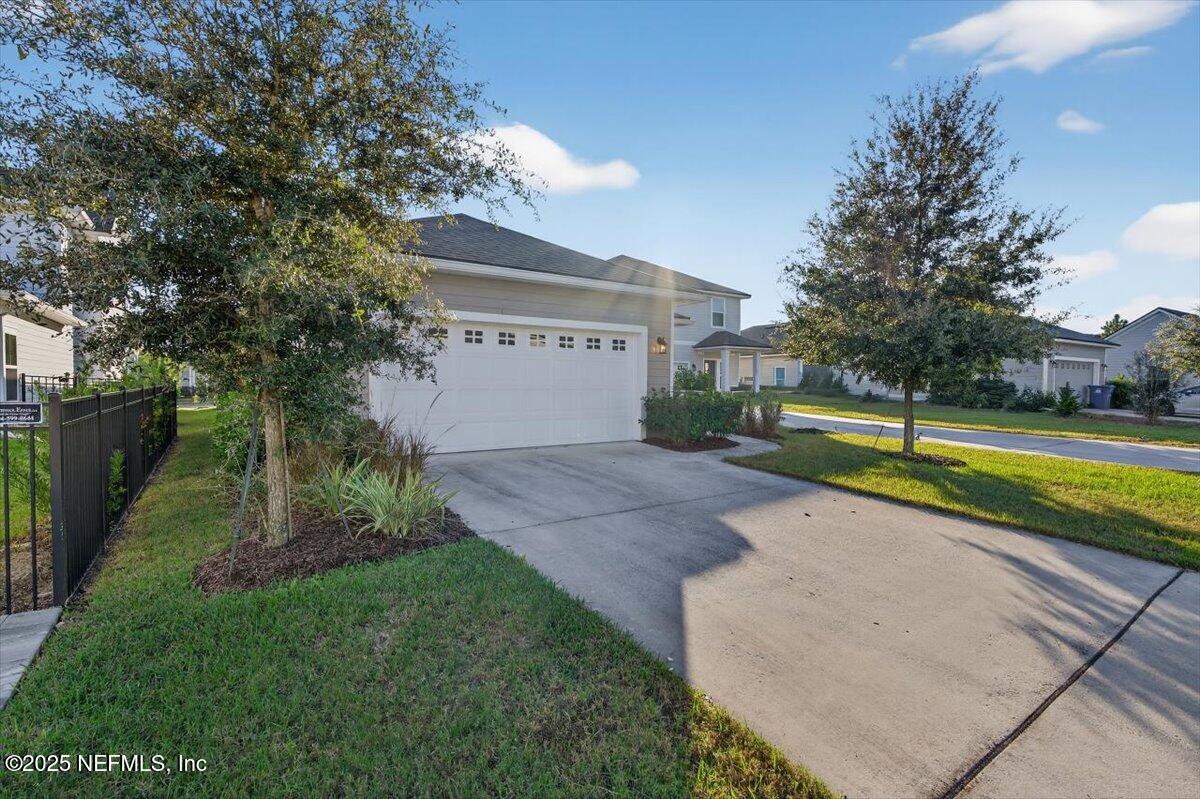 312 Clarys Run St. Augustine, FL 32092 - Photo 43 of 99 a view of a house with a yard and a large tree