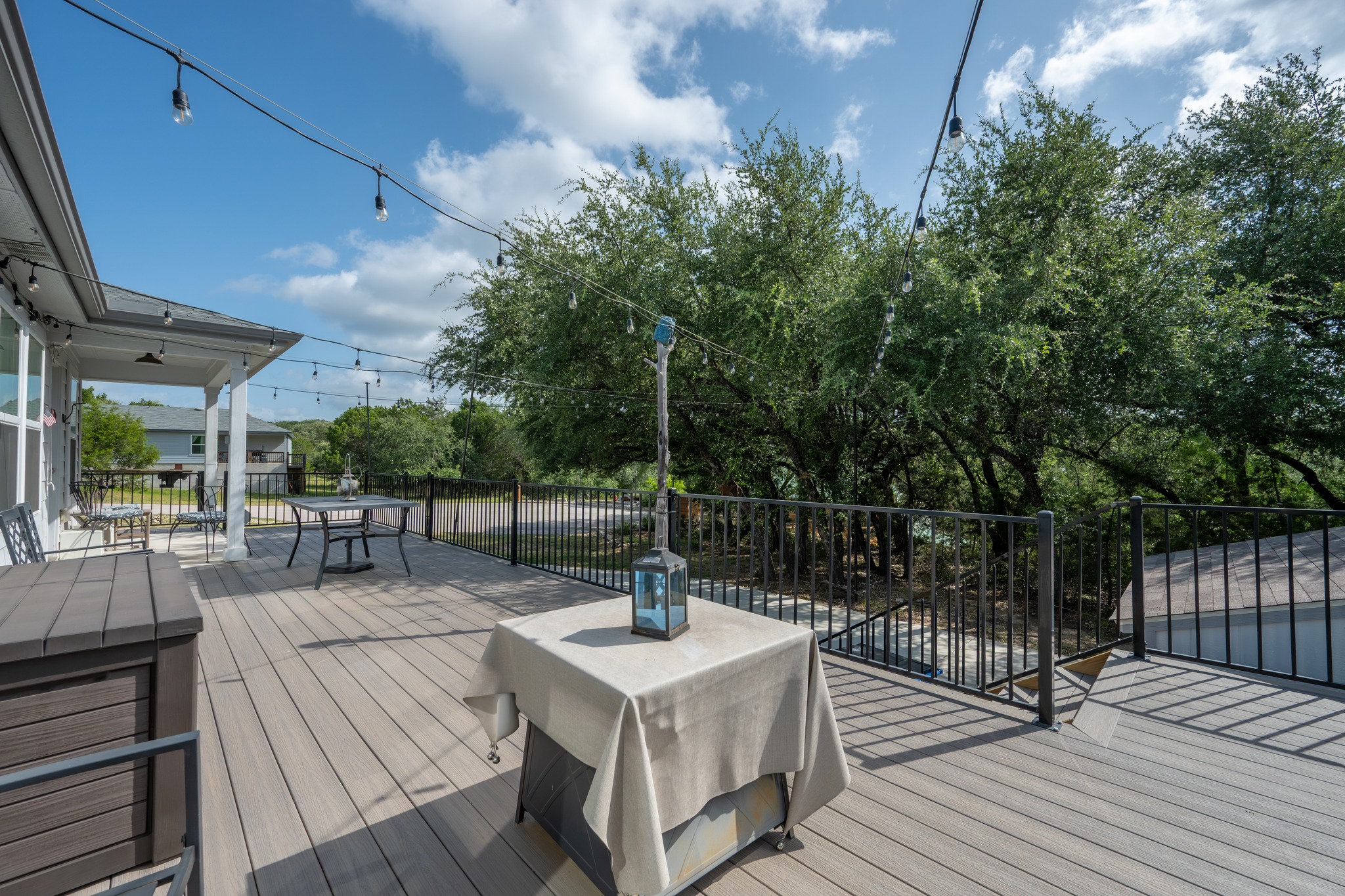 21006 Santa Rosa Avenue Lago Vista, TX 78645 - Photo 19 of 26 An inviting deck with ample space for outdoor relaxation, perfect for entertaining under strung lights.