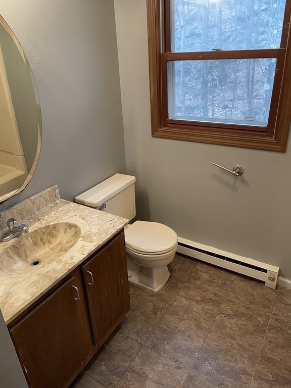 270 Sunderland Road, Unit 76 Worcester, MA 01604 - Photo 16 of 21 a bathroom with a granite countertop sink toilet and mirror