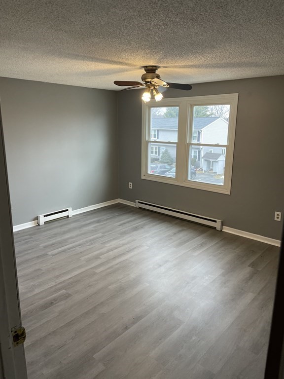 270 Sunderland Road, Unit 76 Worcester, MA 01604 - Photo 10 of 21 an empty room with wooden floor and windows
