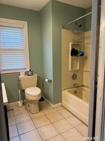 a bathroom with a toilet a sink and bathtub