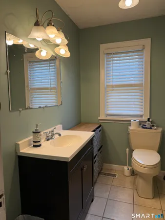 a bathroom with a sink a toilet and a mirror
