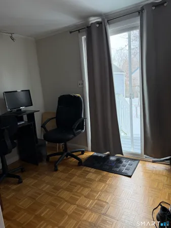 a living room with a chair and a window