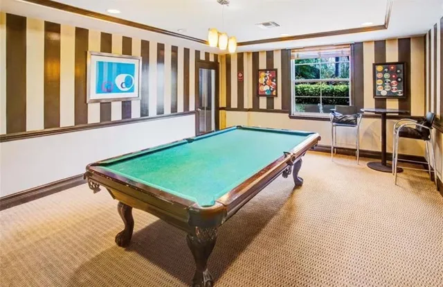 a kitchen with stainless steel appliances granite countertop a stove and cabinets